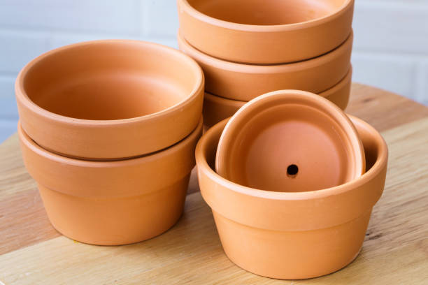 istock Empty rough ceramic brown flower pot isolated on white background 1132434570