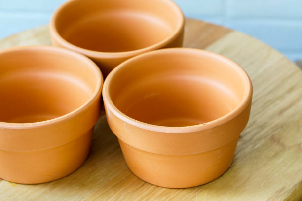istock Empty rough ceramic brown flower pot isolated on white background 1132434571