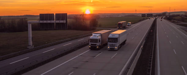 istock Panoramic trucks on the highway at sunset 1132434654