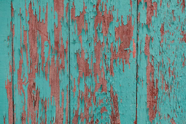 istock cracked vertical wooden panel with peeling green paint, textured surface background 1132437819