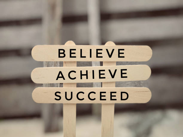 Motivational and inspirational wording. Believie, Achieve, Succeed. Blurred styled background. achievement aiming aspirations attitude stock pictures, royalty-free photos & images