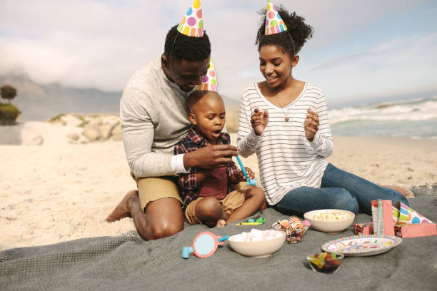 istock Family celebrating son's birthday on beach 1132439559