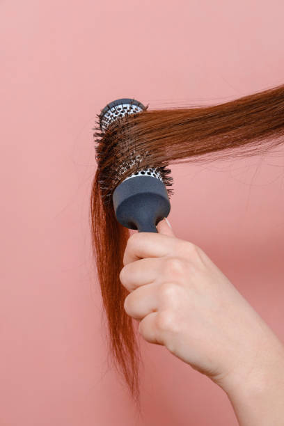 istock comb for hair volume in female hand 1132439608