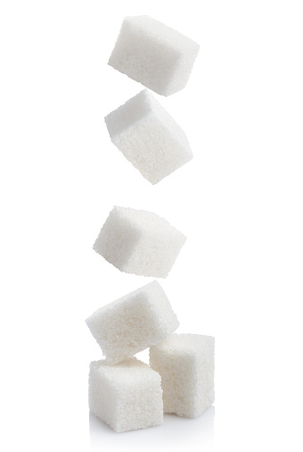 Falling sugar cubes, isolated on white background