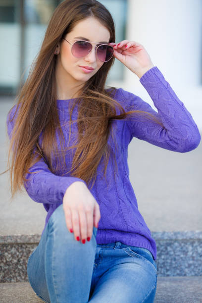 istock Young beautiful woman spends time alone sitting on the steps outdoors on a Sunny day in spring 1132440917