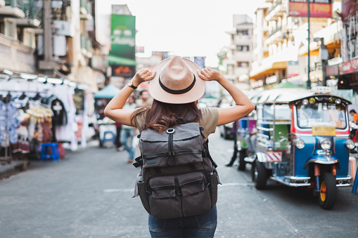 istock Back view Asian woman tourist backpacker travel in Khao San road, Bangkok, Thailand 1132442986