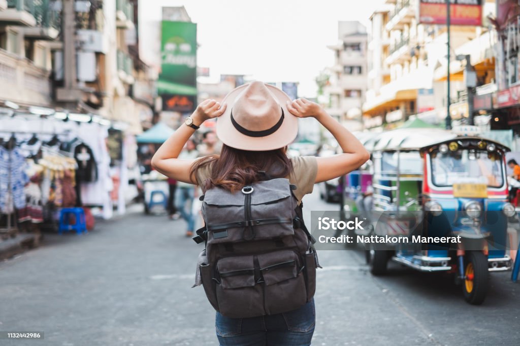 Back view Asian woman tourist backpacker travel in Khao San road, Bangkok, Thailand Travel Stock Photo Back view Asian woman tourist backpacker travel in Khao San road, Bangkok, Thailand Travel Stock Photo