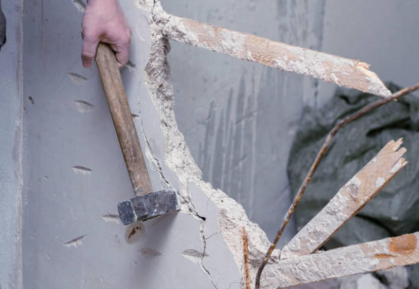 istock demolition work and rearrangement. worker with sledgehammer destroying wall 1132443517