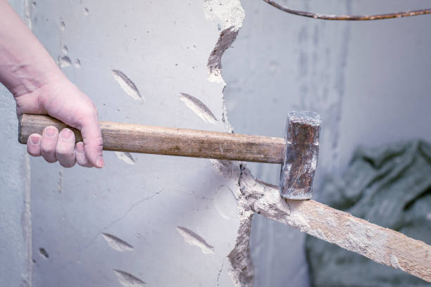 istock demolition work and rearrangement. worker with sledgehammer destroying wall 1132444419