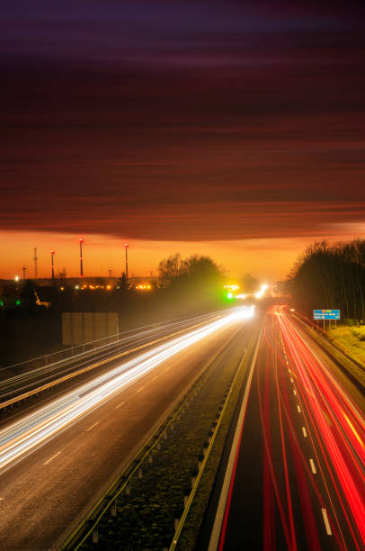 istock the light trails on motorway highway during a dramatic sunset 1132444809