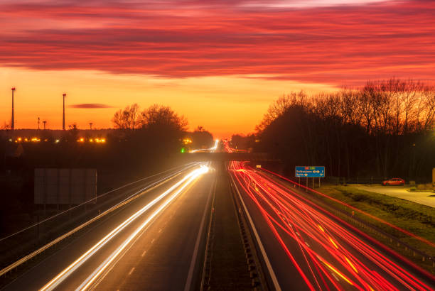 istock the light trails on motorway highway during a dramatic sunset 1132444961