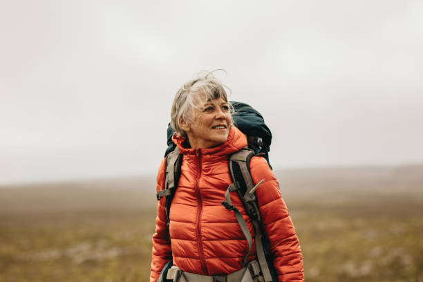 istock Female hiker enjoying the view standing on a hill 1132445026
