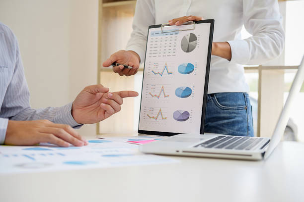istock Business adviser analyzing financial figures denoting the progress Internal Revenue Service checking document. Audit concept 1132445123