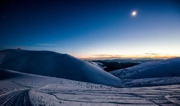 istock Night moon in the snowy mountains 1132448064