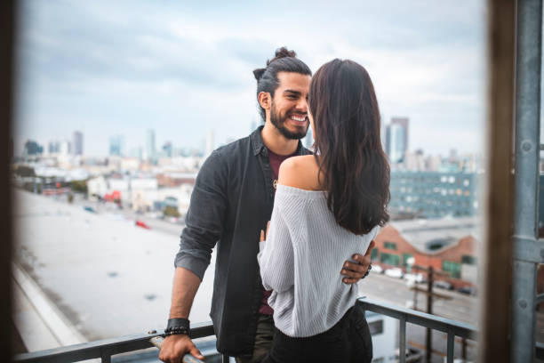 istock Latino couple embracing each other and standing on a balcony 1132448575