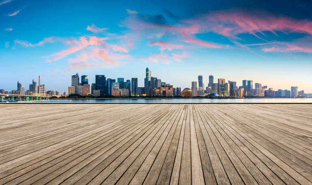 istock Empty wooden platform and Hangzhou city skyline at sunrise 1132448643