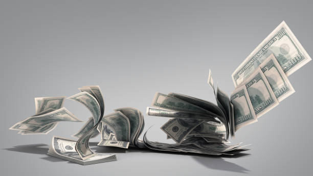 istock dollar hundred bills banknotes blows away from the pile 3d render on grey 1132449696
