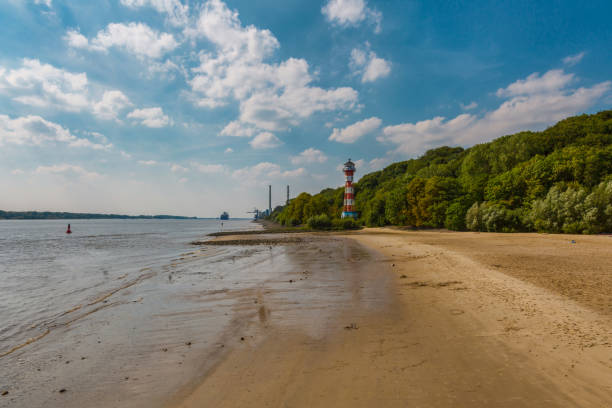 Lighthouse Wittenbergen at river Elbe near Hamburg at low tide Beach scene at the beach in Hamburg elbe river stock pictures, royalty-free photos & images