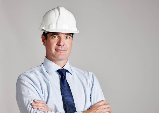 istock Cheerful construction professional in hard hat, arms crossed 1132450757