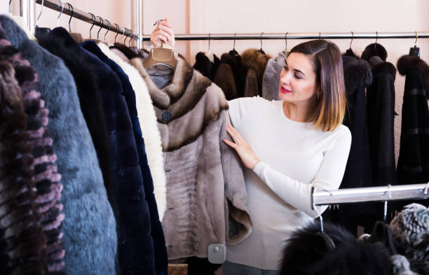 istock Girl deciding on fur jacket 1132453773