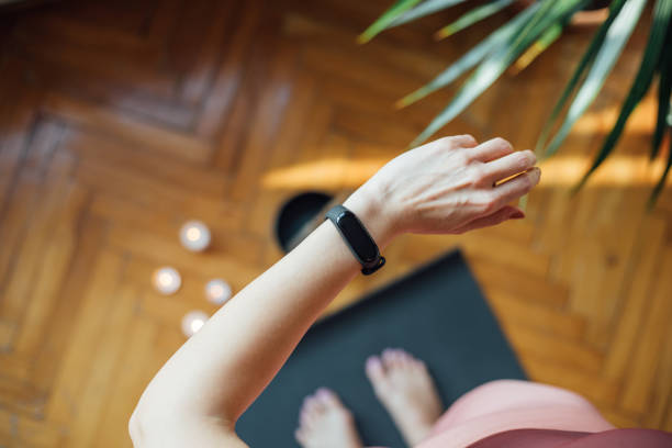 frau prüft herzfrequenz mit smartwatch - checking the time watch women looking stock-fotos und bilder