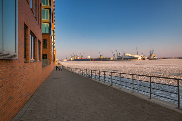istock Winter walk along the quay wall in the harbor 1132457842
