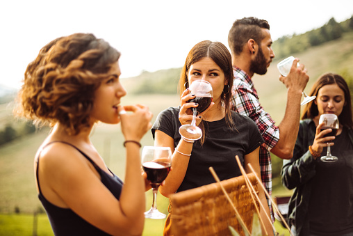 people drinking red wine outdoors