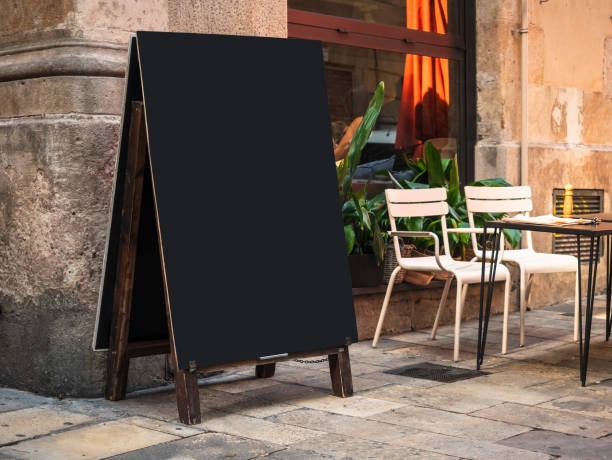 Mock up Menu Blank chalkboard Restaurant street cafe with table seats stock photo