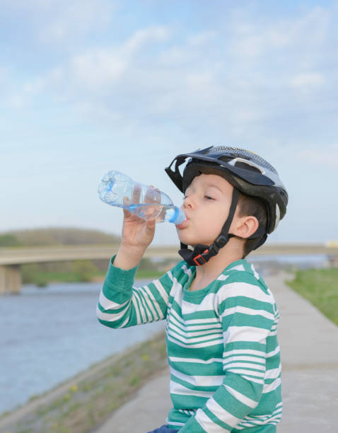 istock Boy resting after ride and drinking water 1132459718