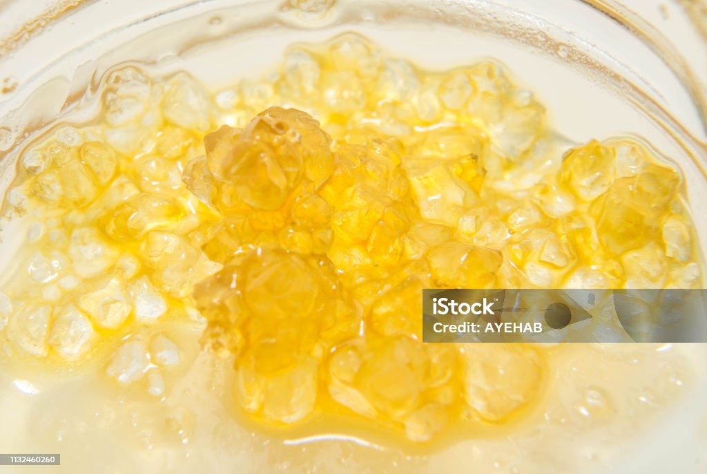 GG4 THCA Crystals In Terpene Sauce, Closer GG4 THCA crystals inside a container. Extracted by 710 Savant. Cannabis - Narcotic Stock Photo
