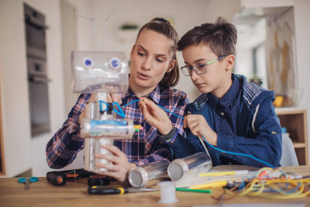 istock Woman teacher and boy constructing a robot together 1132461335