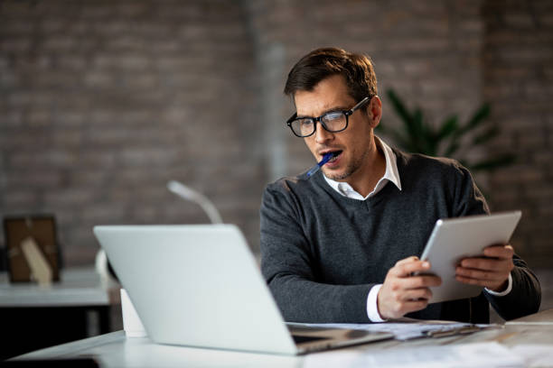 istock Multi-tasking businessman working in the office. 1132462378