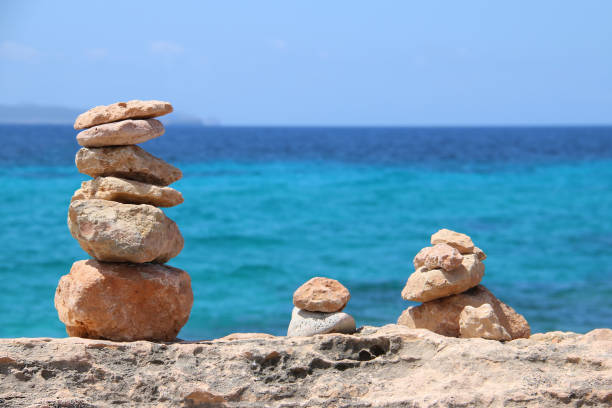 istock Cairn in sunlight at the stone beach 1132463645
