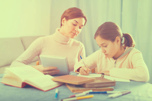 istock Mother and daughter doing school homework 1132463804