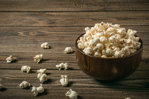 istock Popcorn in a bowl on an old wooden table. 1132464203