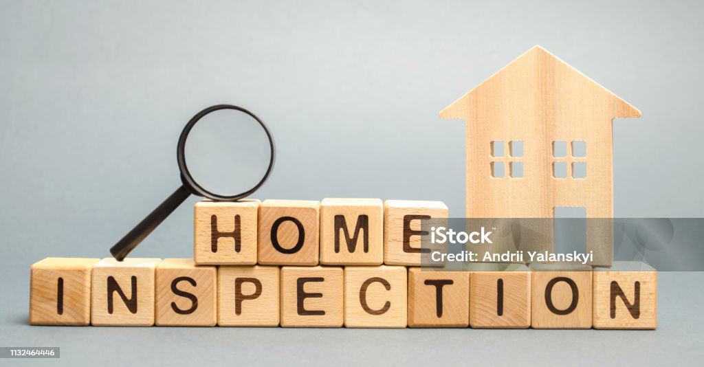 Wooden blocks with the word Home Inspection and the house. Resale residential property condition. The study of the state of the house associated with the sale of housing. Property valuation Quality Control Stock Photo