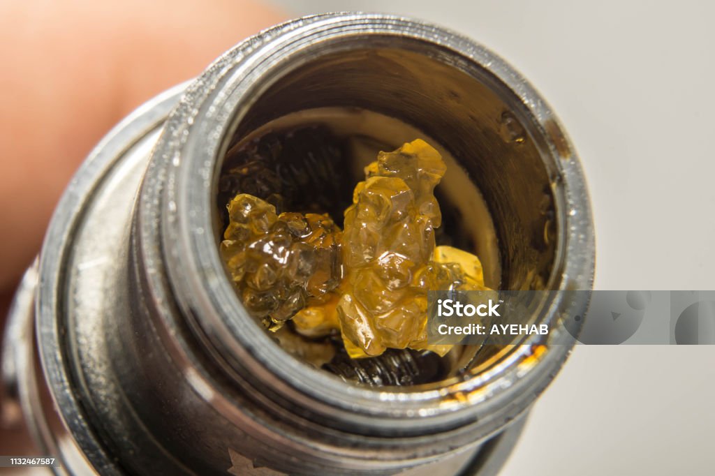 THCA Crystals Inside A Cannabis Extract Vape Pen THCA crystals inside a cannabis extract vape pen. Electronic Cigarette Stock Photo