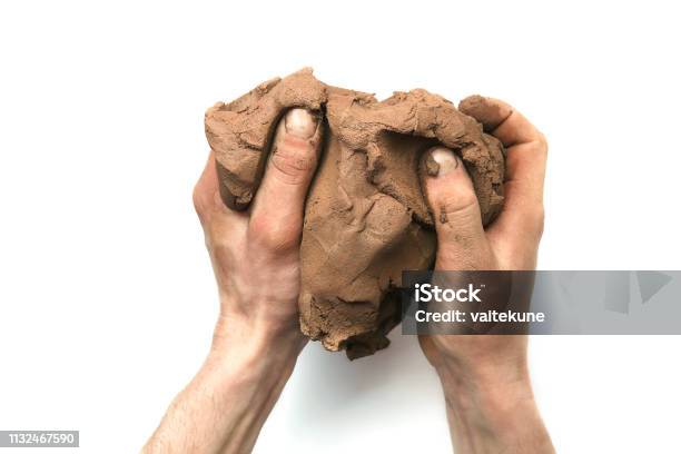 Natural Clay Piece In Hands Isolated On White Background Stock Photo - Download Image Now
