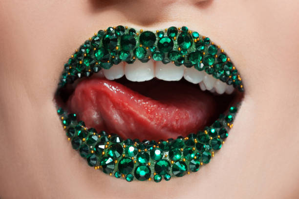 Green lips covered with rhinestones. woman with Green lipstick on her lips stock photo