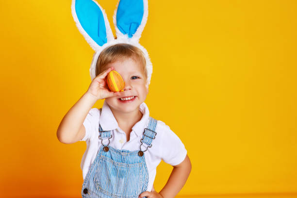 istock funny happy child boy with easter eggs and bunny ears on yellow 1132467909