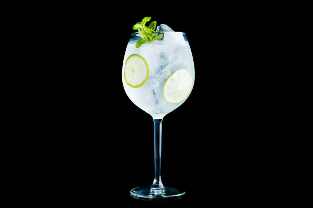 istock Martini royale cocktail in wine glass with lime and mint isolated on black background 1132468292