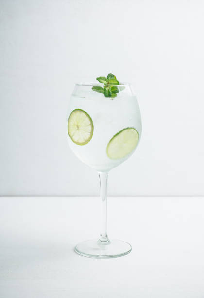 istock Martini royale cocktail in wine glass with lime and mint 1132468298