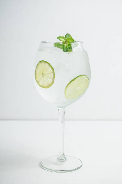 istock Martini royale cocktail in wine glass with lime and mint 1132468299