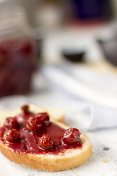 istock Bread with homemade cherry jam on a light background, closeup 1132469745