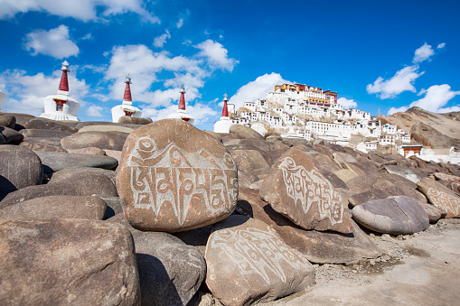 Mani stones in front of Thikse Gompa (monastery) on a winter day. The Monastery was founded back in the 15 century. The buddhist monastery belongs to the Gelug sect (Yellow Hat sect) of Tibetan Buddhism.