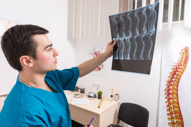 istock Doctor analysing X-ray image of human spine 1132473114