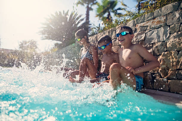 istock Kids playing in swimming pool 1132474682