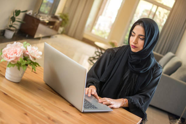 istock Young muslim woman using laptop at home 1132474834