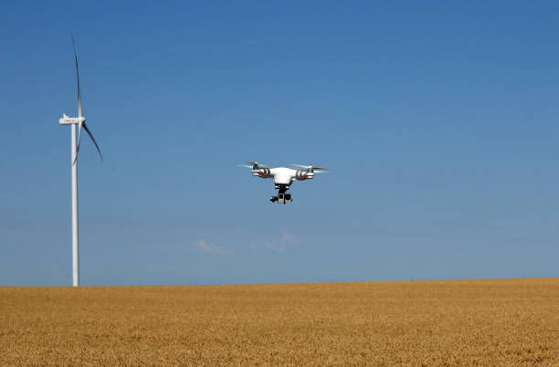 istock drone flying over wheat field with wind turbine 1132475660