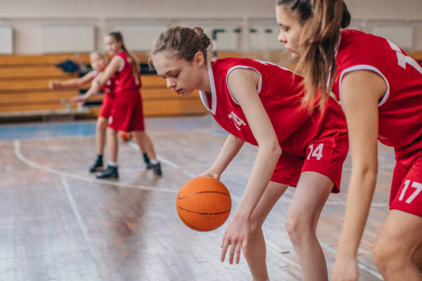 istock Girls playing basketball on training indoors 1132475700
